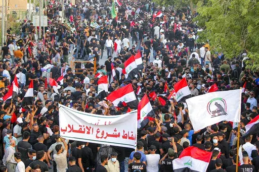 Supporters of Iran-backed Shiite Coordination Framework attend a rally to denounce their rivals, followers of an influential Shiite cleric Muqtada al-Sadr who stormed the parliament last month and have since been holding a sit-in outside the assembly building in Baghdad, Iraq, Friday, Aug. 12, 2022. (AP Photo/Anmar Khalil)