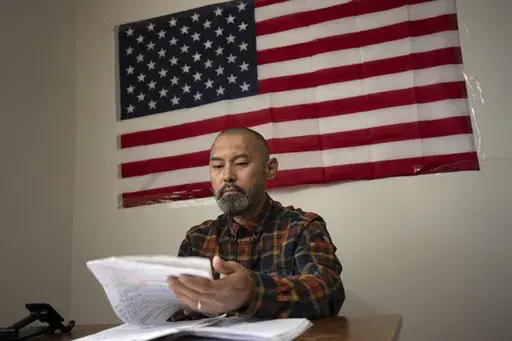 Chinese migrant Li Kai aka Khaled, an ethnic Hui Muslim, studies for a Commercial Driving License in his apartment in Flushing, New York, May 3, 2024. Li Kai came to the U.S. with his wife and two sons seeking religious freedom and a better life. (AP Photo/Serkan Gurbuz, File)