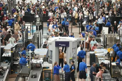 Travelers queue up at the south security checkpoint in Denver International Airport as the Labor Day holiday approaches Tuesday, Aug. 30, 2022, in Denver. (AP Photo/David Zalubowski)