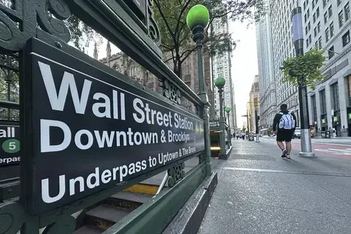 People pass the entrance for the Wall Street subway station on Sept. 2, 2024, in New York. (AP Photo/Peter Morgan, File)