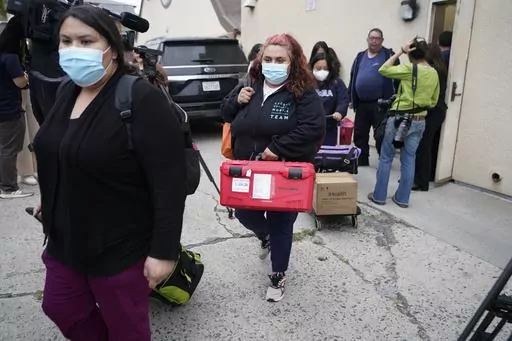 Los Angeles County Public Health Emergency Operations officials leave St. Anthony's Croatian Catholic Church after evaluating the newly arrived migrants being housed in Los Angeles on Wednesday, June 14, 2023. Forty-two people, including some children, were dropped off at Union Station around 4 p.m. Wednesday and were being cared for at the church. Texas Gov. Greg Abbott said the migrants were sent to Los Angeles because California had declared itself a "sanctuary" for immigrants. (AP Photo/Dami