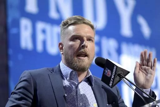 Former Indianapolis Colts player Pat McAfee announces the Colts' third round pick at the NFL football draft, April 26, 2019, in Nashville, Tenn. Retired NFL quarterback Brett Favre is dismissing his lawsuit against McAfee after McAfee publicly apologized for his previous on-air statements that Favre had been “stealing from poor people in Mississippi” in a welfare misspending case. Favre and McAfee both announced the settlement Thursday, May 11, 2023. (AP Photo/Gregory Payan, File)
