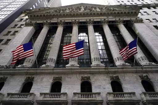 American flags fly outside the New York Stock exchange, Friday, Jan. 14, 2022, in the Financial District in New York. Stocks are off to a weak start on Wall Street, Thursday, Feb. 17, chipping away at the weekly gains for major indexes.  (AP Photo/Mary Altaffer, File)