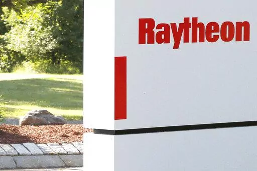 A sign stands at the road leading to the Raytheon facility in Marlborough, Mass., on June 10, 2019. China on Thursday, Feb. 16, 2023, imposed trade and investment sanctions on U.S. military contractors Lockheed Martin and Raytheon for supplying weapons to Taiwan, stepping up efforts to isolate the island democracy claimed by the ruling Communist Party as part of its territory. (AP Photo/Bill Sikes, File)