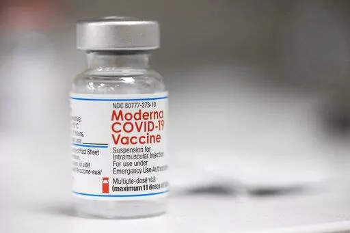 A vial of the Moderna COVID-19 vaccine is displayed on a counter at a pharmacy in Portland, Ore. on Dec. 27, 2021. U.S. health authorities are facing a critical decision: whether to offer COVID-19 booster shots this fall that better match the omicron variant even though the coronavirus already has spawned still more mutants. Moderna and Pfizer are testing updated booster candidates, and advisers to the U.S. Food and Drug Administration will debate Tuesday, June 28, 2022, if it’s time for a swi