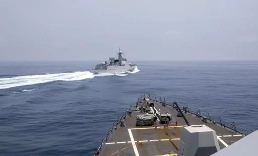 In this photo provided by the U.S. Navy, the USS Chung-Hoon observes a Chinese navy ship conduct what it called an "unsafe” Chinese maneuver in the Taiwan Strait, Saturday, June 3, 2023, in which the Chinese navy ship cut sharply across the path of the American destroyer, forcing the U.S. ship to slow to avoid a collision. The incident occurred as the American destroyer and Canadian frigate HMCS Montreal were conducting a so-called “freedom of navigation” transit of the strait between Taiw