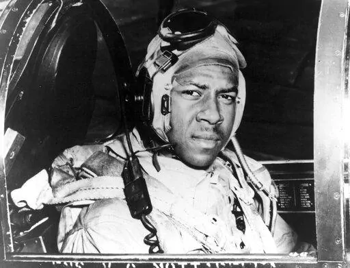 This circa 1950 photo provided by the U.S. Navy shows Jesse Brown in the cockpit of an F4U-4 Corsair fighter at an unidentified location. In December 2022, FedEx founder Fred Smith gifted the proceeds from the film “Devotion,” which he financed, that tells the story of groundbreaking Naval aviators Brown and Thomas Hudner. The proceeds will fund in part scholarships for the children of Navy service members studying STEM. (U.S Navy via AP, File)