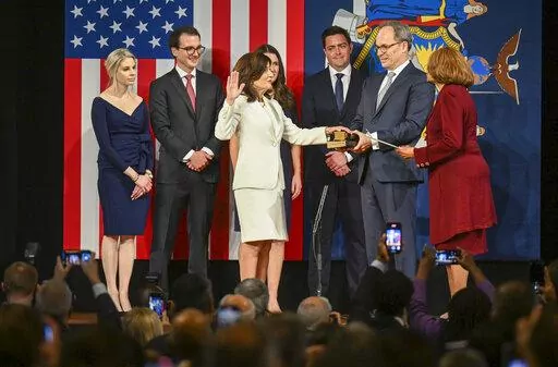 New York Gov. Kathy Hochul, center, is sworn into office as as New York's 57th governor by NAACP President Hazel N. Dukes, right, during an inauguration ceremony, Sunday, Jan. 1, 2023, in Albany, N.Y. With them is from left, is Christina Hochul her husband Will Hochul, Katie Hochul her husband Matt Gloudeman, and Bill Hochul. (AP Photo/Hans Pennink)