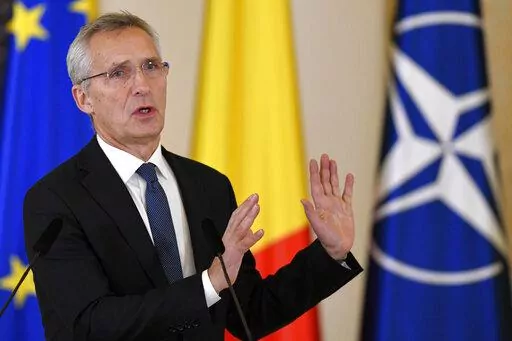 NATO Secretary-General Jens Stoltenberg gestures during joint statements with Romanian President Klaus Iohannis in Bucharest, Romania, Monday, Nov. 28, 2022, a day before the start of the meeting of NATO Foreign Ministers. NATO returns to the scene of one of its most controversial decisions and where it intends to repeat its vow that Ukraine, now suffering through the tenth month of a war against Russia, will be able to join the world's biggest military alliance one day. (AP Photo/Alexandru Dobr