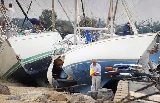Boat owners gather their belongings along the shore in Dartmouth, Mass., Aug. 20, 1991, after Hurricane Bob swept through southern Massachusetts. New England is known for its fickle weather, powerful nor'easters and blizzards. Destructive hurricanes, however, are relatively rare and typically don't pack the same punch as tropical cyclones that hit the Southeast. Hurricanes usually lose some steam, becoming tropical storms, or extratropical storms, in northern waters. (AP Photo/Susan Walsh, File)