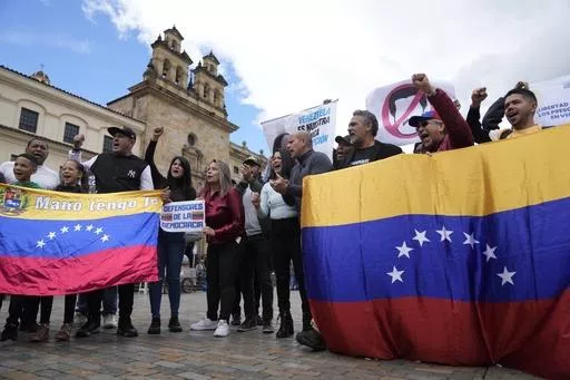 Venezuelans, who support opposition leader María Corina Machado, sing their native country's national anthem during a protest demanding free and fair elections in Venezuela's upcoming election, in Bolivar Square in Bogota, Colombia, April 6, 2024. Of the millions of Venezuelans who have fanned out around the world, including those who migrated before the economic crisis, only about 107,000 are registered to vote outside the South American country. (AP Photo/Fernando Vergara, File)