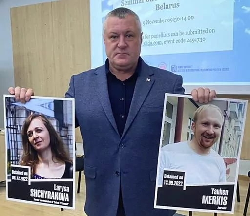 In this handout photo from the Viasna Human Rights Center, Leanid Sudalenka, an activist from Belarus, holds portraits of imprisoned journalists Larysa Shchyrakova and Yauhen Merkis, in Belostok, Poland, Sunday, Nov. 5, 2023. Sudalenka, who was imprisoned for three years in Belarus, said authorities there hold political prisoners in conditions amounting to "torture." He told The Associated Press that when he was in a Belarusian penal colony, he nearly died from COVID-19 and a lack of medical car