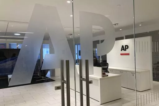 The Associated Press logo is shown at the entrance to the news organization's office in New York on Thursday, July 13, 2023. The Associated Press has issued guidelines for its journalists on use of artificial intelligence, saying the tool cannot be used to create publishable content and images for the news service. (AP Photo/Aaron Jackson, File
