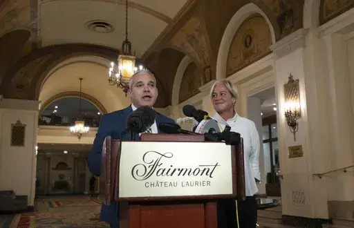 Fairmont Chateau Laurier General Manager Genevieve Dumas looks on as Ottawa Police Services Detective Akiva Gellar speaks about the stolen Yousuf Karsh portrait of Winston Churchill, during a news conference in the hotel in Ottawa, Canada, Wednesday, Sept. 11, 2024. (Adrian Wyld/The Canadian Press via AP)