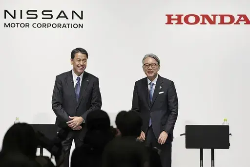 Nissan Chief Executive Makoto Uchida, left, and Honda President Toshihiro Mibe attend a joint news conference in Tokyo, Friday, March 15, 2024. (Kyodo News via AP, File)