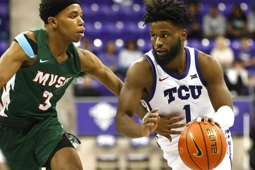 TCU guard Mike Miles Jr. (1) handles the ball as Mississippi Valley State guard Kadar Waller (3) defends during the second half of an NCAA college basketball game, Sunday, Dec. 18, 2022, in Fort Worth, Texas. (AP Photo/Ron Jenkins)