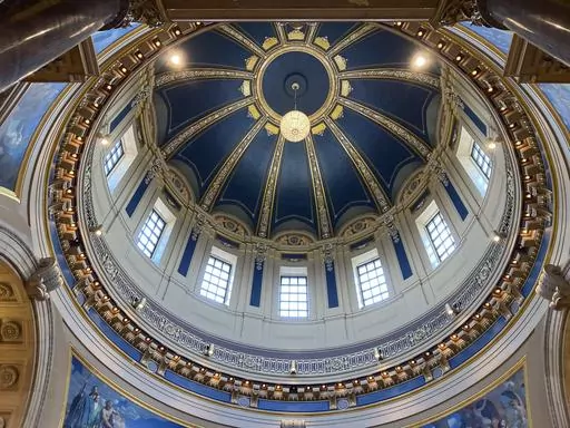 The "electrolier" is lit in the Minnesota State Capitol dome in St. Paul, Minn., Thursday, May 11, 2023, to mark Statehood Day, Minnesota's 165th birthday. The electrolier," an old term for "electric chandelier," is over 100 years old, dating from when electricity was new. It measures 6 feet in diameter, contains 92 light bulbs and hangs over 140 feet above the floor in the Capitol Rotunda. It's lit only on special occasions, such as the annual Statehood Day or on the first days of legislative s