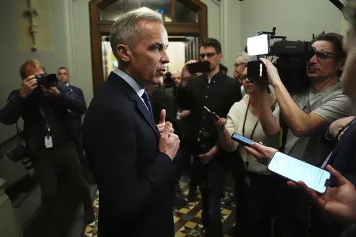Canada Liberal Leader Mark Carney talks to media as he leaves a caucus meeting in Ottawa, Monday, March 10, 2025. (Sean Kilpatrick/The Canadian Press via AP)