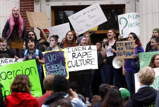 University of Oregon students and staff protest on the steps of Johnson Hall on the UO campus in Eugene, Ore. Thursday May 8, 2014, against sexual violence in the wake of allegations of rape brought against three UO basketball players by a fellow student. (AP Photo/The Register-Guard, Chris Pietsch, File)