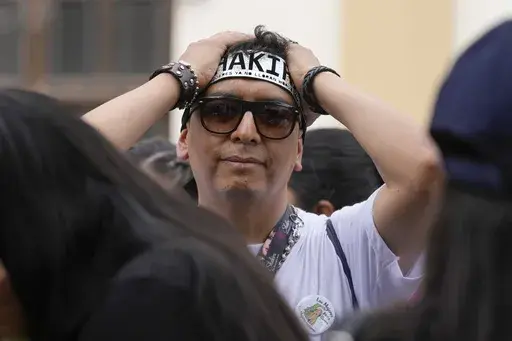A fan of Colombian pop star Shakira reacts outside of the National Stadium upon learning she canceled her concert after being hospitalized, in Lima, Peru, Sunday, Feb. 16, 2025. (AP Photo/Martin Mejia)