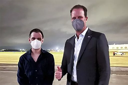 Trevor Reed, left, a Texas resident arrested in Russia in 2019, is greeted by Rep. August Pfluger, R-Texas, at a military airfield in Texas, Thursday, April 28, 2022.   (Jonathan Franks via AP)