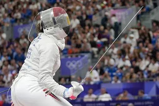 Egypt's Nada Hafez competes with United States' Elizabeth Tartakovsky in the women's individual Sabre round of 32 competition during the 2024 Summer Olympics at the Grand Palais, Monday, July 29, 2024, in Paris, France. (AP Photo/Andrew Medichini)