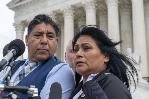 Beatriz Gonzalez, right, the mother of 23-year-old Nohemi Gonzalez, a student killed in the Paris terrorist attacks, and stepfather Jose Hernandez, speak outside the Supreme Court, Feb. 21, 2023, in Washington. The Supreme Court on Thursday, May 18, sidestepped a case against Google that might have allowed more lawsuits against social media companies. The justices' decision returns to a lower court the case from the family of Nohemi Gonzalez. The family wants to sue Google for YouTube videos the