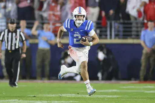 Mississippi quarterback Jaxson Dart (2) runs the ball during the second half of an NCAA college football game against Georgia on Saturday, Nov. 9, 2024, in Oxford, Miss. Mississippi won 28-10. (AP Photo/Randy J. Williams)