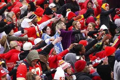 Fans do the tomahawk chop during the Kansas City Chiefs' victory celebration and parade in Kansas City, Mo., Wednesday, Feb. 15, 2023, following the Chiefs' win over the Philadelphia Eagles Sunday in the NFL Super Bowl 57 football game. (AP Photo/Reed Hoffmann)