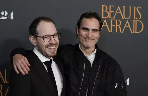 Ari Aster, left, writer/director of "Beau Is Afraid," and star Joaquin Phoenix pose together at the premiere of the film, Monday, April 10, 2023, at the Directors Guild of America in Los Angeles. (AP Photo/Chris Pizzello)