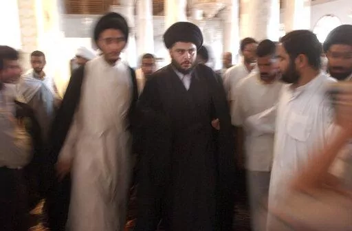 Muqtada al-Sadr is seen during prayers at the Al-Kufa Mosque Friday, July 18, 2003, in the holy city of Najaf, south of Baghdad, Iraq. Al-Sadr is a populist cleric, who emerged as a symbol of resistance against the U.S. occupation of Iraq after the 2003 invasion. (AP Photo/Wally Santana, File)
