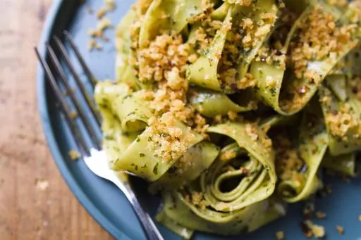 This image released by Milk Street shows a recipe for pappardelle with basil, anchovy and toasted breadcrumbs. (Milk Street via AP)
