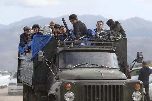 Ethnic Armenians from Nagorno-Karabakh travel on a truck on their way to Kornidzor, Armenia, on Sept. 26, 2023. Israel has quietly helped fuel Azerbaijan’s campaign to recapture Nagorno-Karabakh, officials and experts say, supplying powerful weapons to Azerbaijan ahead of its lightening offensive last month that brought the Armenian enclave in its territory back under its control.(Stepan Poghosyan, Photolure photo via AP, File)
