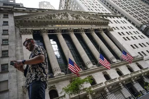 Pedestrians walk past the New York Stock Exchange, July 8, 2022, in New York. Stocks are opening slightly higher on Wall Street Thursday, July 28, 2022 following news the U.S. economy shrank for a second consecutive quarter. The S&P 500, Dow Jones Industrial Average and Nasdaq are each up a fraction of a percent. (AP Photo/John Minchillo, file)