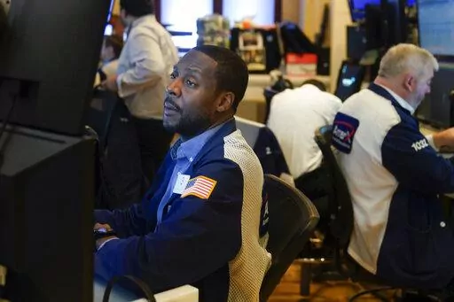 Traders work on the floor at the New York Stock Exchange in New York, Wednesday, July 27, 2022. (AP Photo/Seth Wenig)