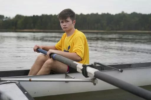 Callum Bradford rows during a club team practice at Jordan Lake, Friday, Oct. 6, 2023, in Apex, N.C. Bradford, a transgender teen from Chapel Hill needed mental health care after overdosing on prescription drugs. He was about to be transferred to another hospital due to a significant bed shortage. A North Carolina hospital network is referring transgender psychiatric patients to treatment facilities that do not align with their gender identities. Though UNC Hospitals policy discourages the pract