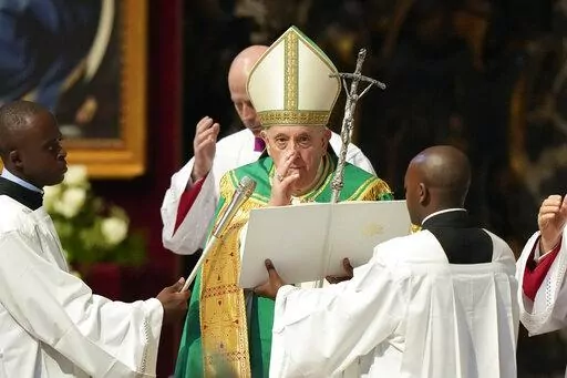 Pope Francis delivers his blessing at the end of a mass for the Congolese community he presided in St. Peter's Basilica, at the Vatican, Sunday, July 3, 2022. (AP Photo/Andrew Medichini)