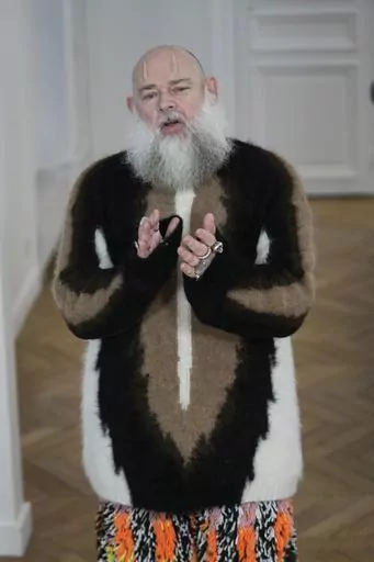Designer Walter van Beirendonck applauds after the presentation of his Menswear ready-to-wear Fall-Winter 2024-2025 collection in Paris Wednesday, Jan. 17, 2024 in Paris. (AP Photo/Michel Euler)