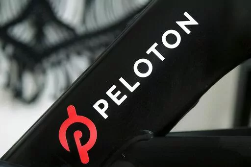 A Peloton logo is seen on the company's stationary bicycle on Nov. 19, 2019, in San Francisco. In a statement  on Wednesday, Aug. 24, 2022, Peloton announced that their high-end exercise bikes and other gear will now be available for purchase on Amazon in the U.S., a partnership aimed at boosting the fitness company's sales that have languished since the easing of pandemic lockdowns. (AP Photo/Jeff Chiu, File)