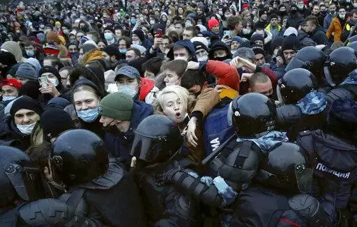 People clash with police during a protest against the jailing of opposition leader Alexei Navalny in St. Petersburg, Russia, Saturday, Jan. 23, 2021. In pressure unprecedented in post-Soviet Russia, since the imprisonment of Navalny, scores of activists, independent journalists and rights advocates have been targeted with raids, detentions and designations as terrorists and foreign agents. (AP Photo/Dmitri Lovetsky, File)