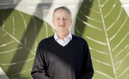 Computer scientist Geoffrey Hinton poses at Google's Mountain View, Calif, headquarters on Wednesday, March 25, 2015. Computer scientists who helped build the foundations of today's artificial intelligence technology are warning of its dangers, but that doesn't mean they agree on the risks or how to prevent disastrous outcomes. (AP Photo/Noah Berger, File)
