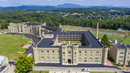 This July 15, 2020, file photo shows the barracks at Virginia Military Institute in Lexington, Va. The Virginia Military Institute will change its student-run honor court to make it more fair to cadets as part of a response to a state-ordered investigation into racism and sexism. The Washington Post reports VMI detailed the reforms in a progress report Friday, Feb. 4, 2022. (AP Photo/Steve Helber, File)