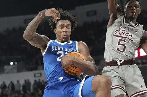 Kentucky center Amari Williams (22) pulls down a rebound in front of Mississippi State guard Shawn Jones Jr. (5) during the second half of an NCAA college basketball game, Saturday, Jan. 11, 2025, in Starkville, Miss. (AP Photo/Rogelio V. Solis)