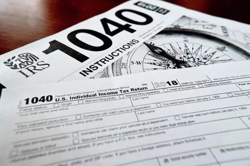 FILE- Internal Revenue Service taxes forms are seen on Feb. 13, 2019. If you have unpaid or unfiled taxes, the start of a new tax season and the looming reminders of debt might fill you with dread. But it’s best to take care of back taxes sooner rather than later: The longer you put off the task, the more you’ll pay in interest and penalties. Even if you can’t pay in full, you can still take meaningful steps toward addressing the debt. To handle your overdue taxes, read any tax notices you