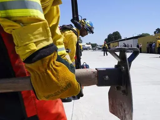 Cadets, who were formerly-incarcerated firefighters, train at the Ventura Training Center (VTC) during an open house media demonstration Thursday, July 14, 2022, in Camarillo, Calif. California has a first-in-the nation law and a $30 million training program both aimed at trying to help former inmate firefighters turn pro after they are released from prison. The 18-month program is run by Cal Fire, the California Conservation Corps, the state corrections department and the nonprofit Anti-Recidiv