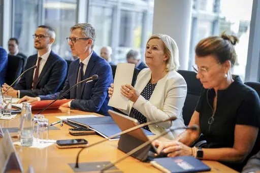 Federal Minister of the Interior and Home Affairs Nancy Faeser, second from right, attends the special session of the Bundestag's Committee on Internal Affairs, in Berlin, Friday, Aug. 30, 2024. Germany deported Afghan nationals to their homeland on Friday for the first time since August 2021, when the Taliban returned to power. (Kay Nietfeld/dpa via AP)