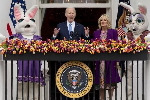 President Joe Biden, accompanied by first lady Jill Biden and Easter Bunnies, speaks on the Blue Room balcony at the White House during the White House Easter Egg Roll, April 18, 2022, in Washington. (AP Photo/Andrew Harnik, File)