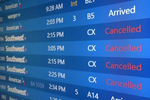 The list of Southwest Airlines flights cancelled grows at Phoenix Sky Harbor International Airport in Phoenix, Dec. 29, 2022. Thousands of air travelers faced flight cancellations and delays this weekend as thunderstorms traveled across the U.S. East Coast and Midwest. (AP Photo/Ross D. Franklin, File)