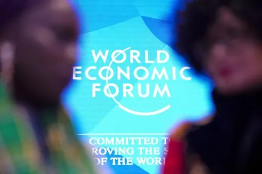 People talk in front of the logo of the World Economy Forum on the last day of the forum's Annual Meeting at the Congress Center in Davos, Switzerland, Friday, Jan. 19, 2024. On Friday, Jan. 19, The Associated Press reported on stories circulating online incorrectly claiming a deadly contagion known as Disease X is emerging and under discussion at the World Economic Forum’s 2024 annual meeting in Davos. (AP Photo/Markus Schreiber, File)
