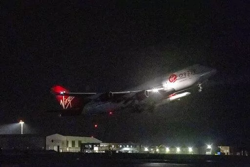 A repurposed Virgin Atlantic Boeing 747 aircraft, named Cosmic Girl, carrying Virgin Orbit's LauncherOne rocket, takes off from Spaceport Cornwall at Cornwall Airport, Newquay, England, Monday, Jan. 9, 2023. The plane will carry the rocket to 35,000 feet where it will be released over the Atlantic Ocean to the south of Ireland, as part of the Start Me Up mission and the first rocket launch from U.K. The rocket will take multiple small satellites, with a variety of civil and defence applications,